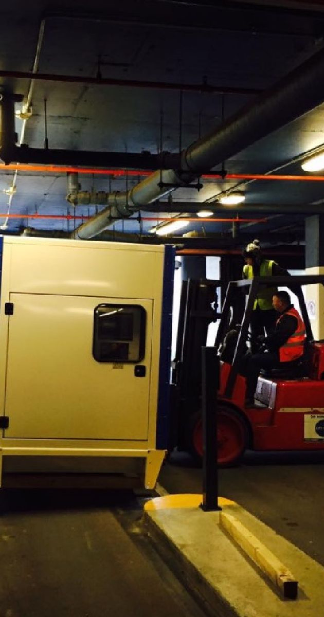 Forklift moving a large generator 