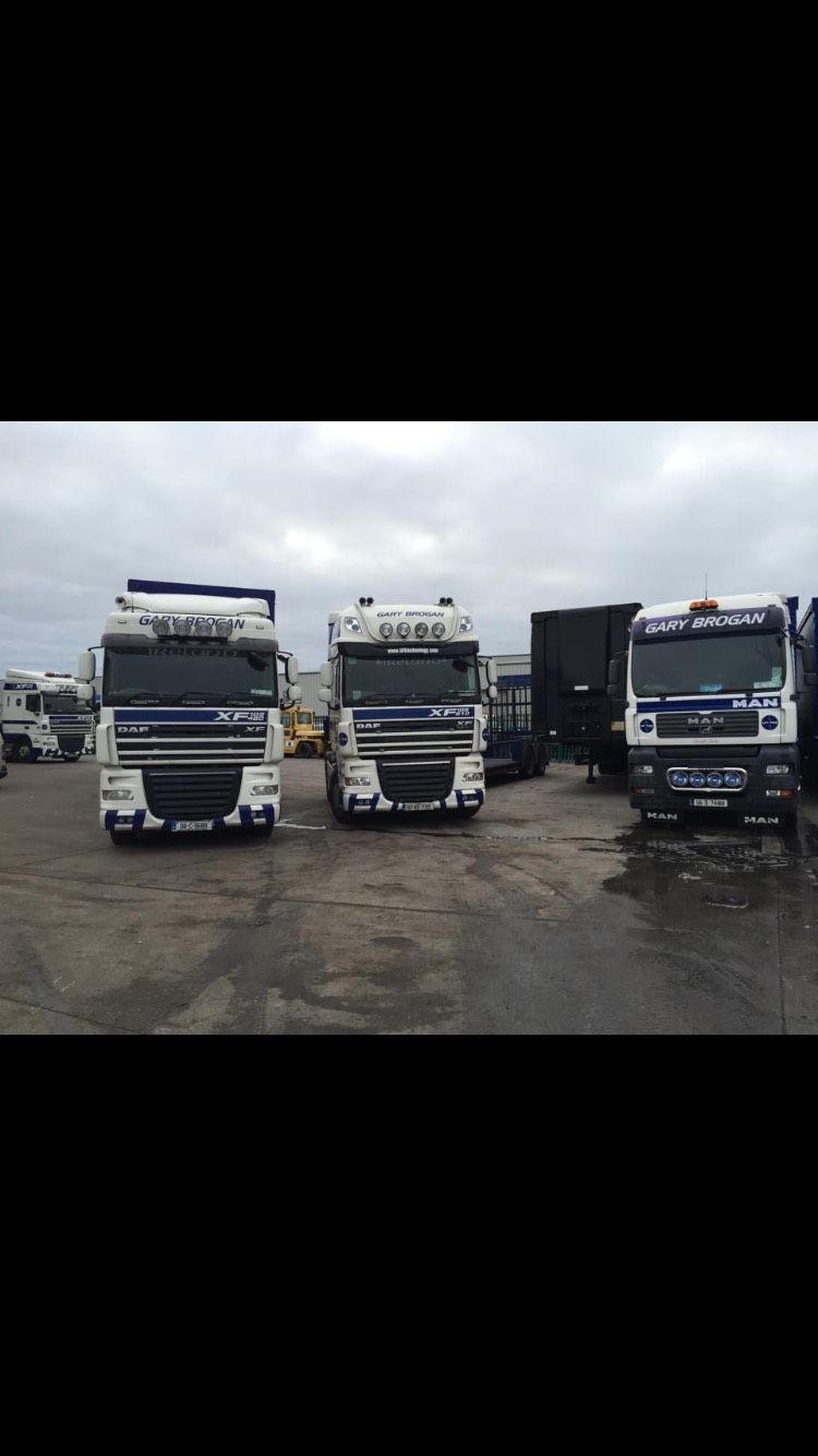 Three lorries parked and ready to be loaded