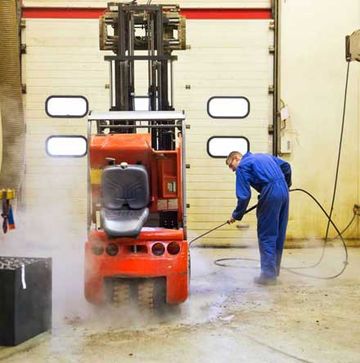 An Orange Forklift being serviced