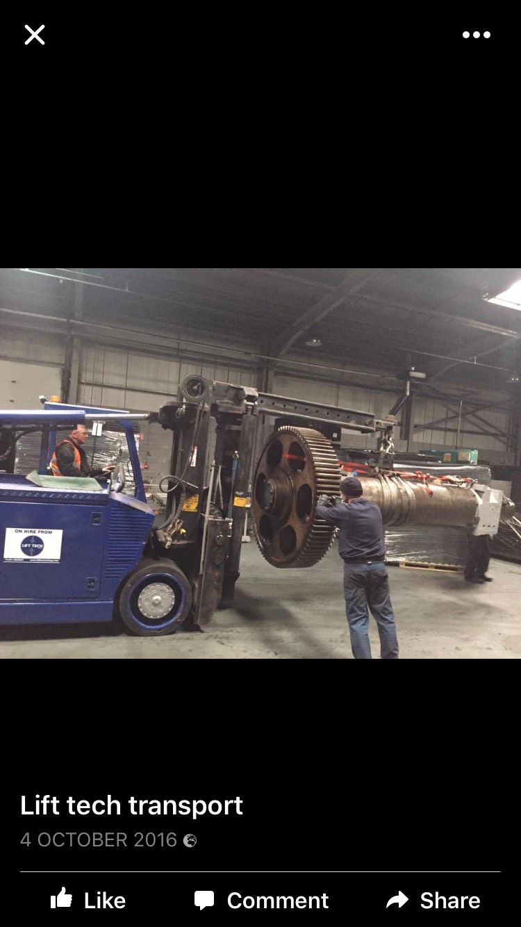 Blue forklift moving large industrial component